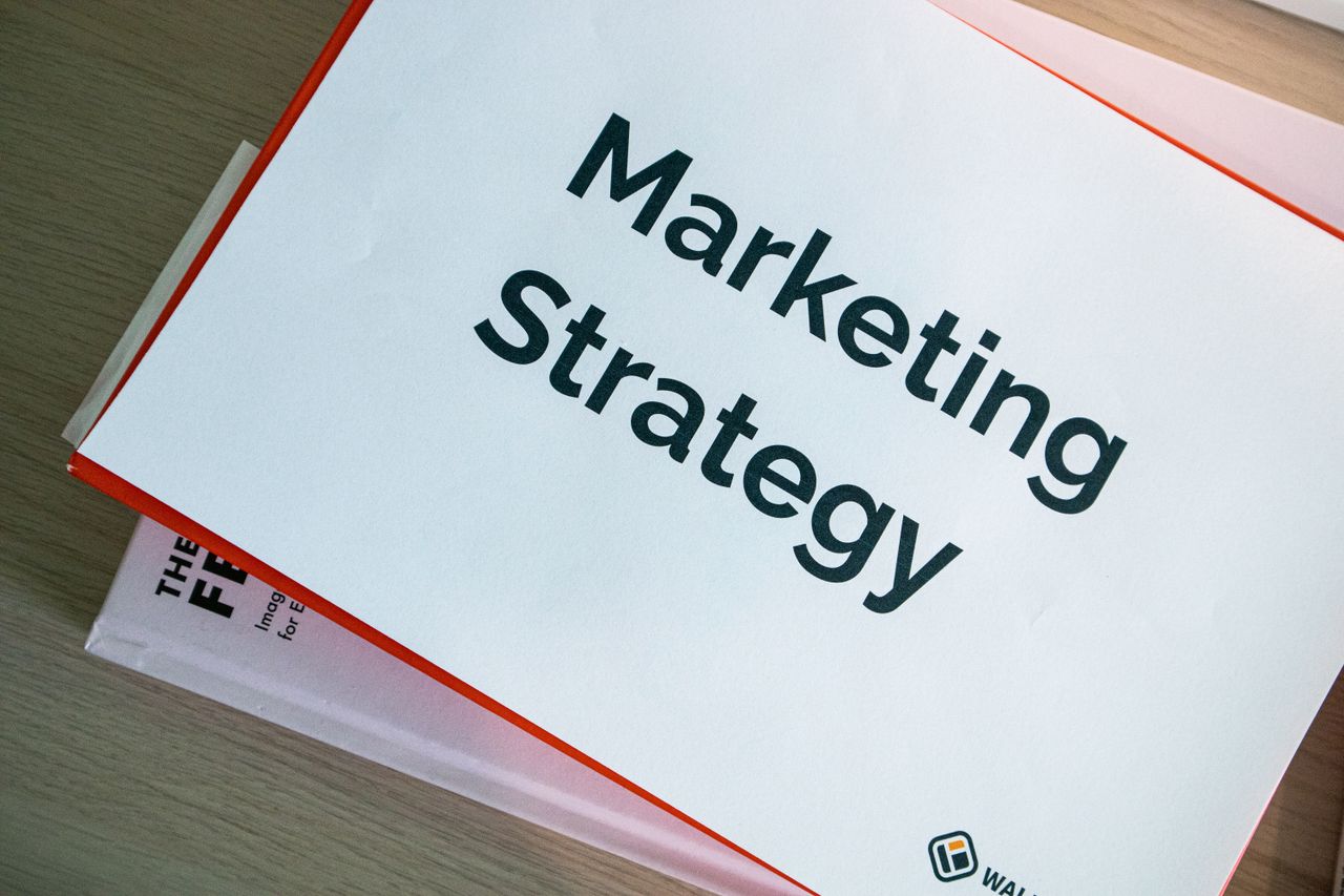 services-03 A marketing strategy document displayed on a desk, showcasing business planning essentials.